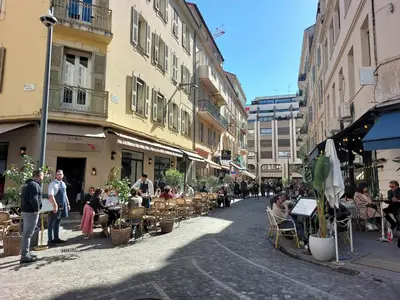 a street with a group of people sitting in chairs at Gray d'Albion - Cannes Rue d'Antibes - 2 Minutes walk from Beach, Palais des Festivals, Boulevard de la Croisette - Free Parking in Cannes