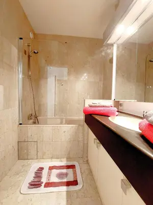 a bathroom with a shower and a sink and a tub at Gray d'Albion - Cannes Rue d'Antibes - 2 Minutes walk from Beach, Palais des Festivals, Boulevard de la Croisette - Free Parking in Cannes