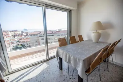 a dining room with a table and a large window at Very Nice View by Connexion in Cannes