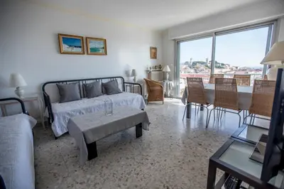 a bedroom with a bed and a table and chairs at Very Nice View by Connexion in Cannes