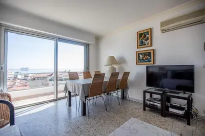 a dining room with a table and a television at Very Nice View by Connexion in Cannes