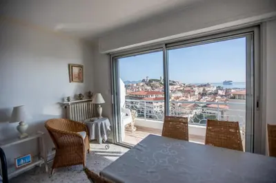 a dining room with a table and a large window at Very Nice View by Connexion in Cannes