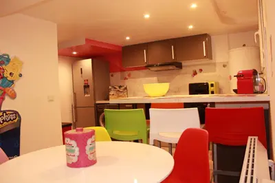 a kitchen with a table and colorful chairs at Appart'hôtel Art Deco in Cannes