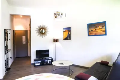 a living room with a couch and a table at ACCI Cannes Gallia in Cannes