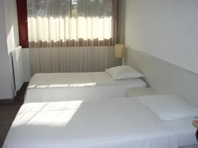two white beds in a room with a window at ACCI Cannes Gallia in Cannes