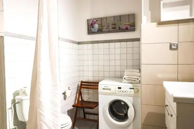 a small bathroom with a washing machine in it at ACCI Cannes Gallia in Cannes