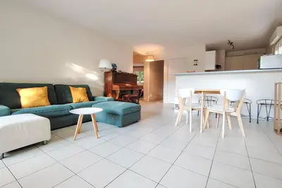 a living room with a blue couch and a table at Charming & bright flat with AC Garden 300m and Closed Garage - BENAKEY in Cannes