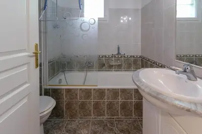 a bathroom with a tub and a sink and a toilet at Charming & bright flat with AC Garden 300m and Closed Garage - BENAKEY in Cannes