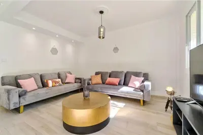 a living room with a couch and a coffee table at Agréable 3pièces Cannes Croisette in Cannes