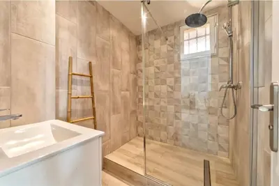 a bathroom with a shower and a sink and a glass shower stall at Agréable 3pièces Cannes Croisette in Cannes