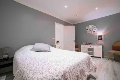 a bedroom with a white bed and a chair at MARIE ANTOINETTE in Cannes