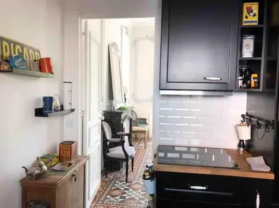 a kitchen with a counter and a chair in a room at MARIE ANTOINETTE in Cannes