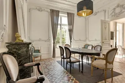a dining room with a table and chairs at MARIE ANTOINETTE in Cannes