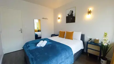 a bedroom with a large bed with two white shoes on it at Palais Carnot central apartment with balcony and A C in Cannes