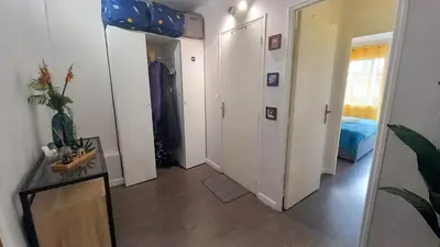 a room with a hallway with white doors and a bed at Palais Carnot central apartment with balcony and A C in Cannes