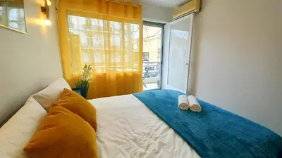 a bedroom with a bed with two towels on it at Palais Carnot central apartment with balcony and A C in Cannes