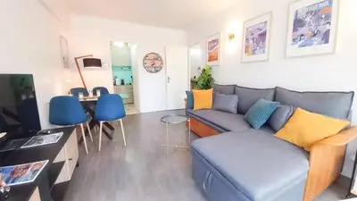 a living room with a couch and a table at Palais Carnot central apartment with balcony and A C in Cannes