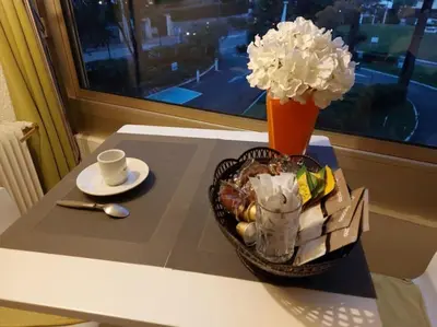 a table with a basket of food and a vase of flowers at Studio Le Trident de la mer - Axelle Loc'Appart in Cannes