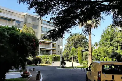 a van parked in a parking lot in front of a building at Studio Le Trident de la mer - Axelle Loc'Appart in Cannes