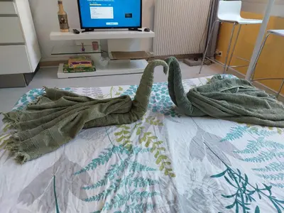 a blanket on top of a bed with a tv at Studio Le Trident de la mer - Axelle Loc'Appart in Cannes
