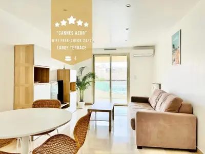 a living room with a couch and a table and chairs at CannesAzur - Appartement Terrasse centre Cannes in Cannes