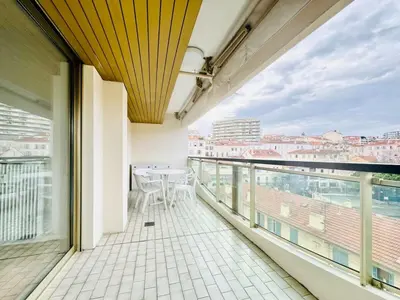 a balcony with a table and a view of the city at CannesAzur - Appartement Terrasse centre Cannes in Cannes