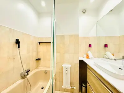 a bathroom with a shower and a sink and a tub at CannesAzur - Appartement Terrasse centre Cannes in Cannes