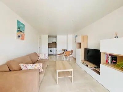 a living room with a couch and a table at CannesAzur - Appartement Terrasse centre Cannes in Cannes