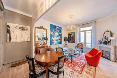 a living room with a table and chairs and a fireplace at L’app’Art Cannes - Contemporain Centre-Ville in Cannes
