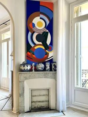 a painting on a wall above a fireplace in a living room at L’app’Art Cannes - Contemporain Centre-Ville in Cannes