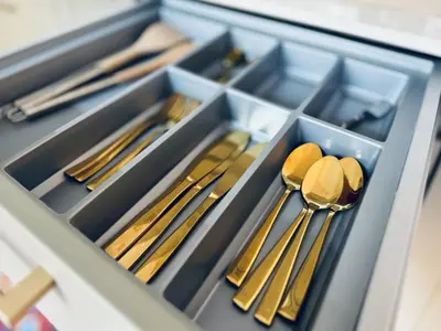 a drawer full of gold utensils in a drawer at L’app’Art Cannes - Contemporain Centre-Ville in Cannes