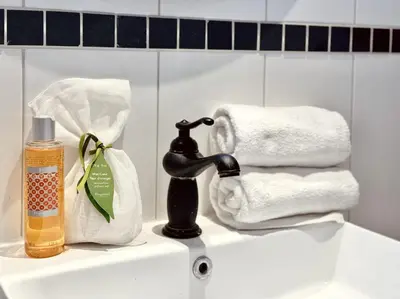 a bathroom sink with a faucet and towels at L’app’Art Cannes - Contemporain Centre-Ville in Cannes