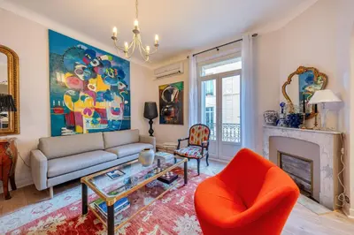 a living room with a couch and a fireplace at L’app’Art Cannes - Contemporain Centre-Ville in Cannes