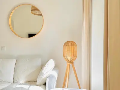 a living room with a white couch and a mirror at Le Bohème - Logement Cozy centre in Cannes