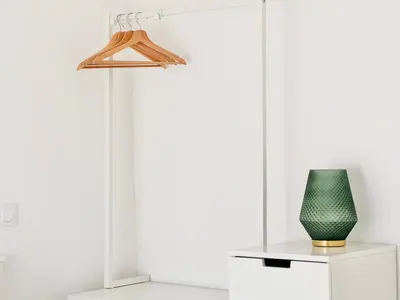 a green vase sitting on a table next to a lamp at Le Bohème - Logement Cozy centre in Cannes