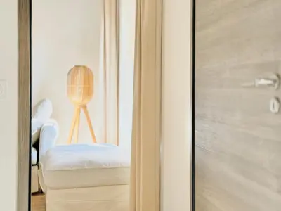 a room with a door with a chair and a lamp at Le Bohème - Logement Cozy centre in Cannes