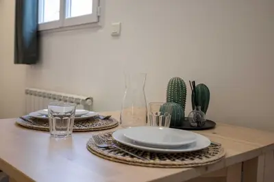 a table with plates and glasses on top of it at Studio Alexandre - Cannes in Cannes