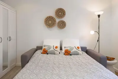 a bedroom with a bed with pillows on it at Studio Alexandre - Cannes in Cannes