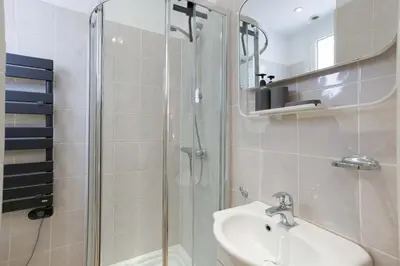 a bathroom with a glass shower and a sink at Studio Alexandre - Cannes in Cannes
