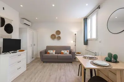 a living room with a couch and a table at Studio Alexandre - Cannes in Cannes