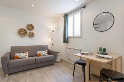 a living room with a couch and a table at Studio Alexandre - Cannes in Cannes