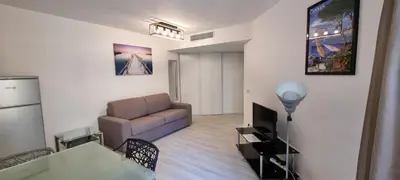 a large white bed with a towel on it at Vieux Port One Bedroom Apartment B22 in Cannes