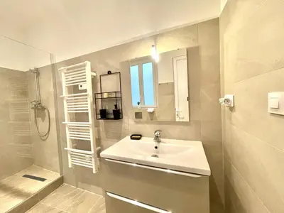 a white bathroom with a sink and a shower at Woody old town appartement by Welcome to Cannes in Cannes