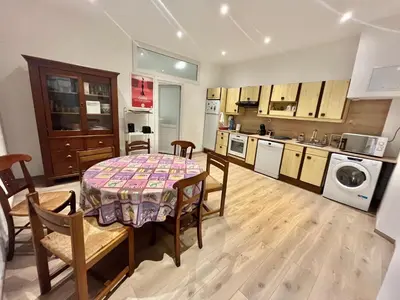 a kitchen and dining room with a table and chairs at Woody old town appartement by Welcome to Cannes in Cannes