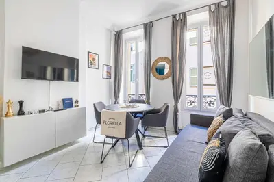 a living room with a couch and a table at LA PERLE au cœur du centre ville, idéal pour séjours loisirs ou business in Cannes