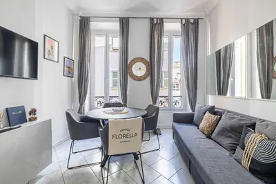 a living room with a couch and a table at LA PERLE au cœur du centre ville, idéal pour séjours loisirs ou business in Cannes