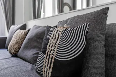a group of pillows sitting on a couch at LA PERLE au cœur du centre ville, idéal pour séjours loisirs ou business in Cannes
