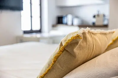 a bedroom with a large white bed with two pillows at Joli studio Cannes marché forville in Cannes