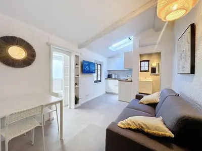 a living room with a couch and a table at Joli studio Cannes marché forville in Cannes