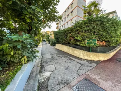 a street with bushes and a sign on it at Cocon Riviera in Cannes